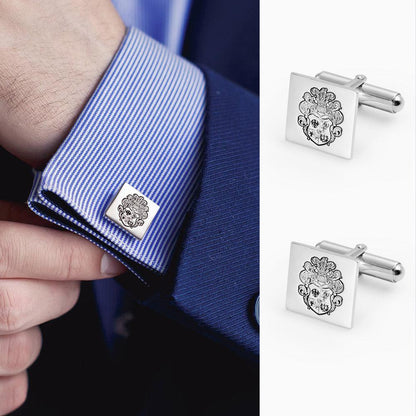 Square silver cufflinks with detailed family crest design, shown on a blue striped shirt cuff.