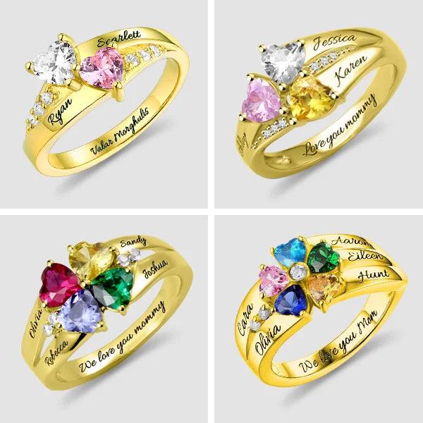 Four gold rings with heart-shaped gemstones in various colors, each personalized with names and inscriptions like "We love you mommy" and "Valor morghulis."