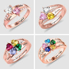 Four rose gold rings with heart-shaped gemstones in various colors, each personalized with names and inscriptions like "We love you mommy" and "Valor morghulis."