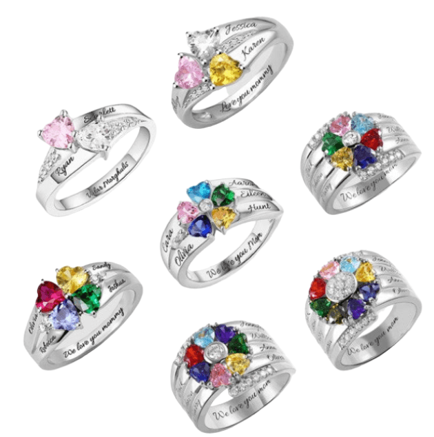 Seven silver rings with heart-shaped gemstones in various colors, each personalized with names and inscriptions like "We love you mommy" and "Valor morghulis."