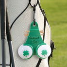Green personalized golf ball and tee holder clipped to a golf bag