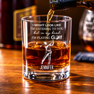 Personalized golf whiskey glass with custom name and golfer design filled with whiskey
