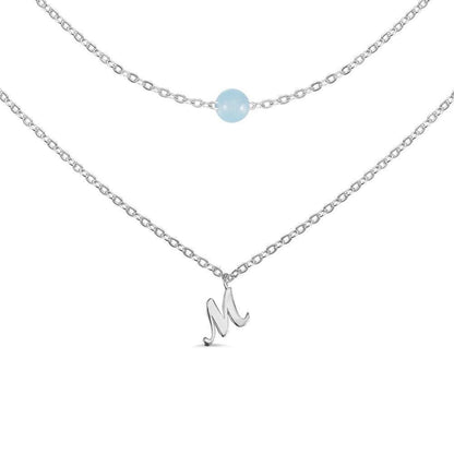 Custom Layered Initials and Tiny Moonstone Birthstone Necklace in silver with an 'M' initial charm and moonstone bead on delicate chains.