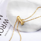 Close-up of a gold Custom Layered Initials and Tiny Moonstone Birthstone Necklace with a unique clasp design, showcasing the chain and fastener.