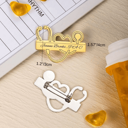 Personalized Medical School Graduation Lapel Pin in gold with custom stethoscope design, showing dimensions of 1.57"/4cm by 1.2"/3cm, next to medical items.