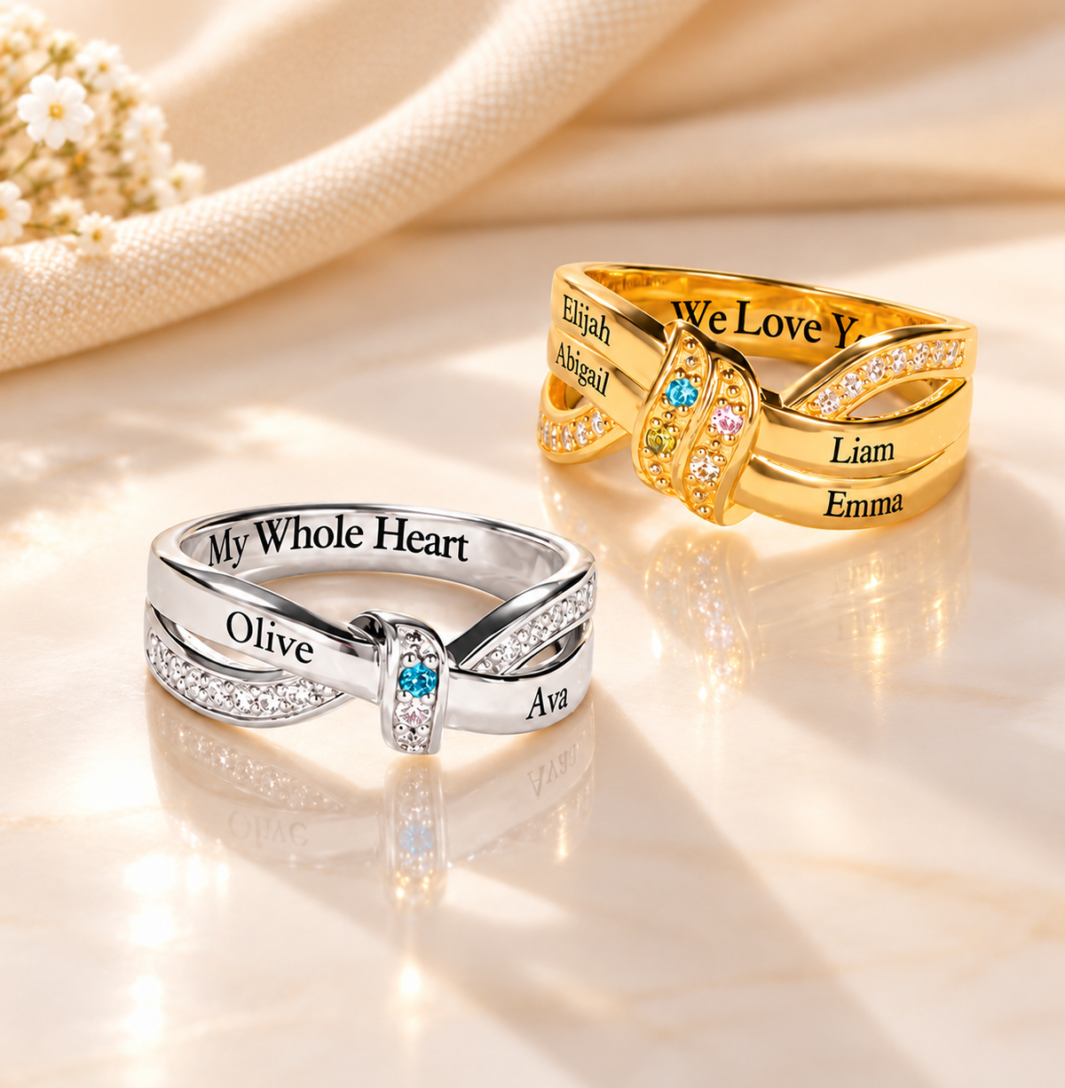 Custom mother's birthstone rings in gold and silver with engraved kids' names, colourful gemstones and an elegant intertwined ribbon design. 