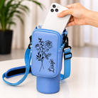 Blue personalized tumbler carrier bag with zippered phone pocket and adjustable strap