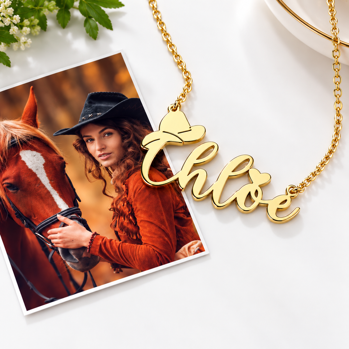Gold custom name necklace with cowboy hat displayed beside a Western cowgirl photo