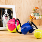 Personalized pink and blue dog tennis ball holders with tennis ball