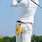 Personalized yellow golf ball sack clipped to golfer belt with carabiner