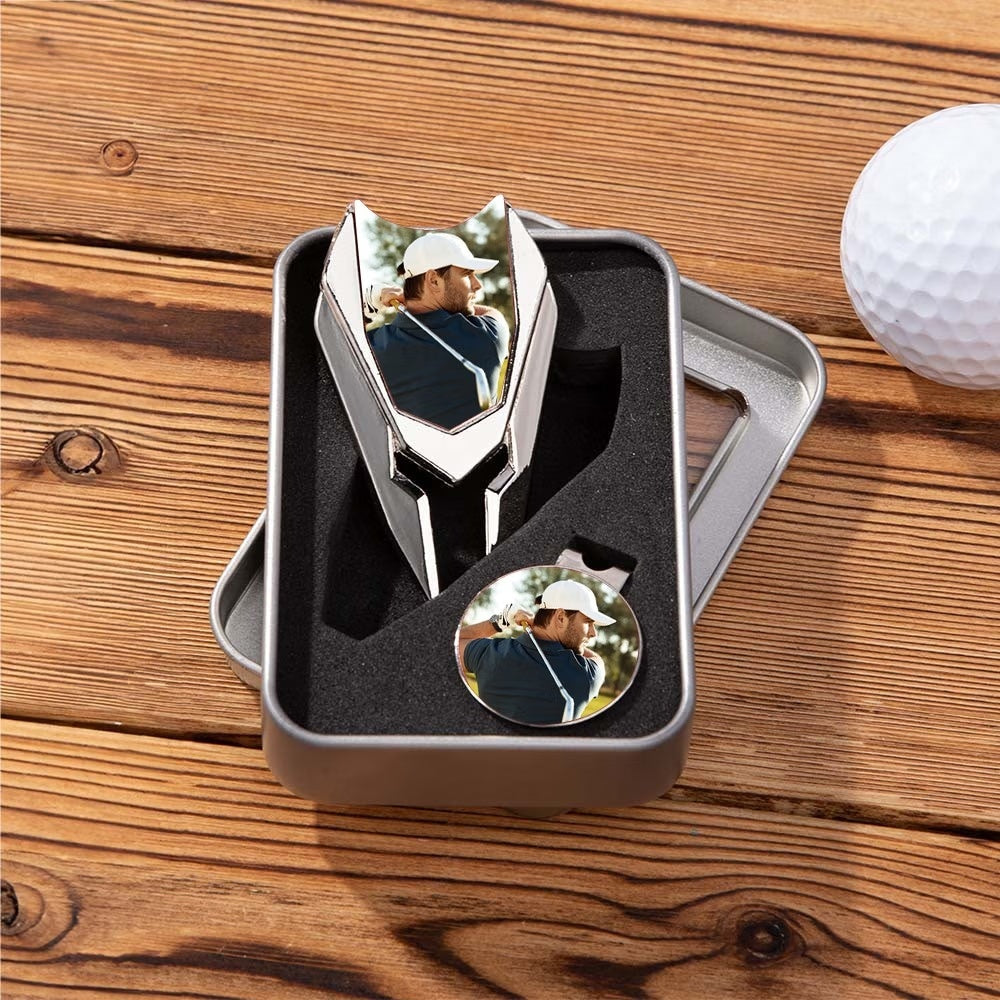 Personalized golf divot repair tool and ball marker gift set displayed on wooden surface