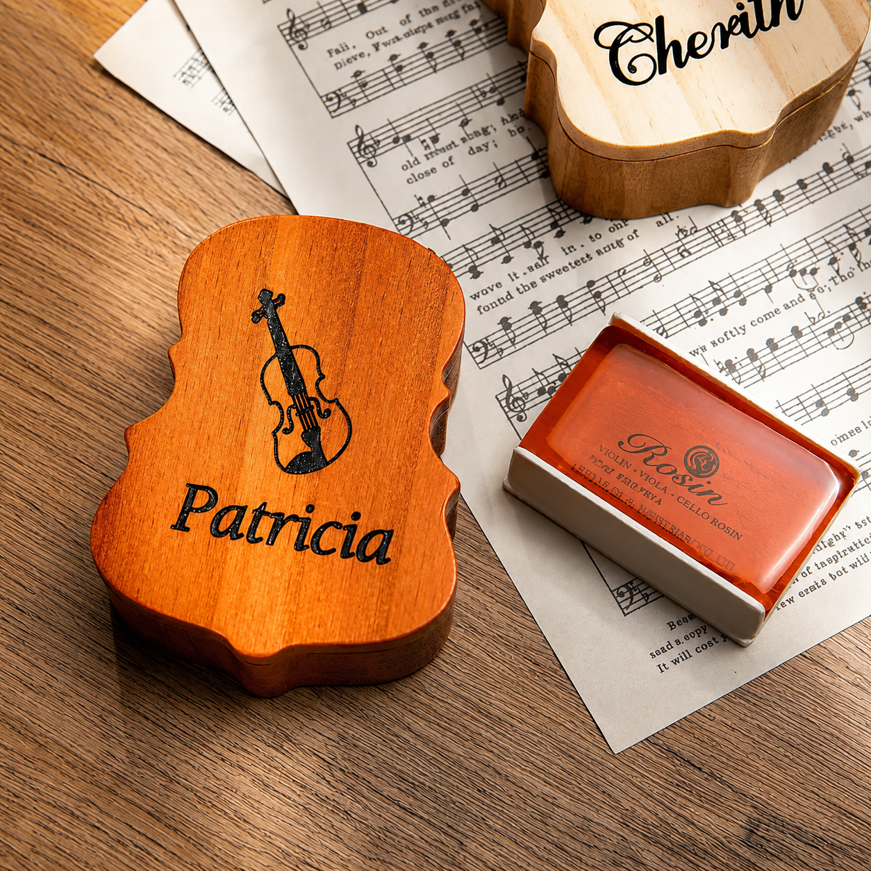 Luxury personalized violin rosin box with engraved name and violin design displayed on a rustic wooden background.