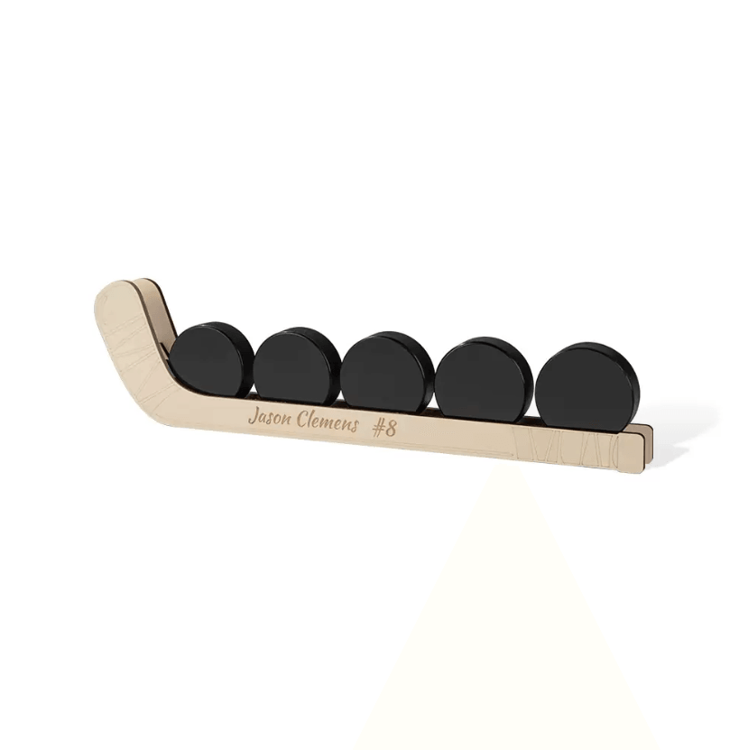 Customizable wooden hockey puck display shelf with five pucks, personalized with the name "Jason Clemens #8", ideal for wall or table decoration.