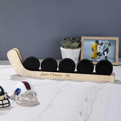 Customizable wooden hockey puck display shelf with five pucks, personalized with the name "Jason Clemens #8", perfect for wall or table decoration.