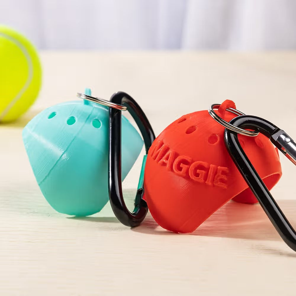 3D printed dog tennis ball holders in turquoise and red with carabiners