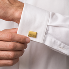 Personalized gold rectangle cufflink worn with white formal shirt