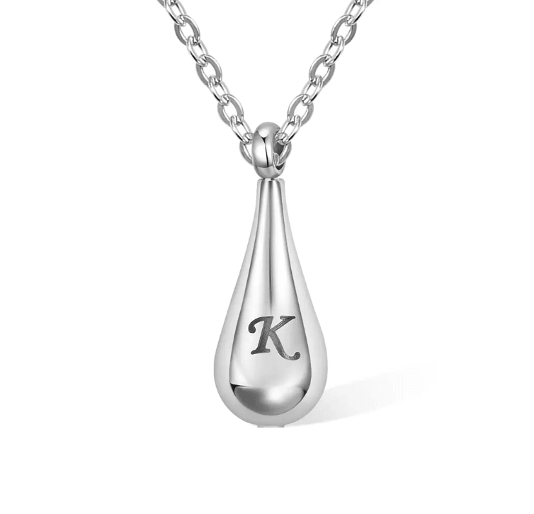 Silver teardrop pendant necklace with the letter "K" on a white background