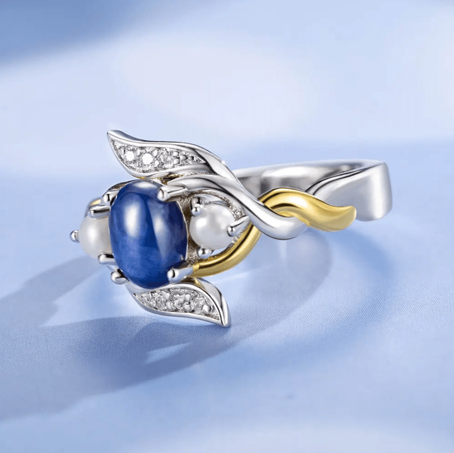 Close-up of Exquisite Blue Star Sapphire and Pearl Ring with Sterling Silver and 18K Gold Plating, featuring intricate design details and custom craftsmanship.