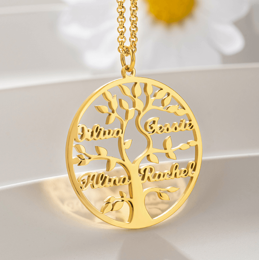 A gold family tree pendant necklace displaying the names Olivia, Jessie, Alina, and Rachel, intricately designed with detailed branches and leaves, hanging on a delicate chain.