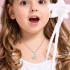 Girl wearing personalized unicorn necklace with crescent moon pendant