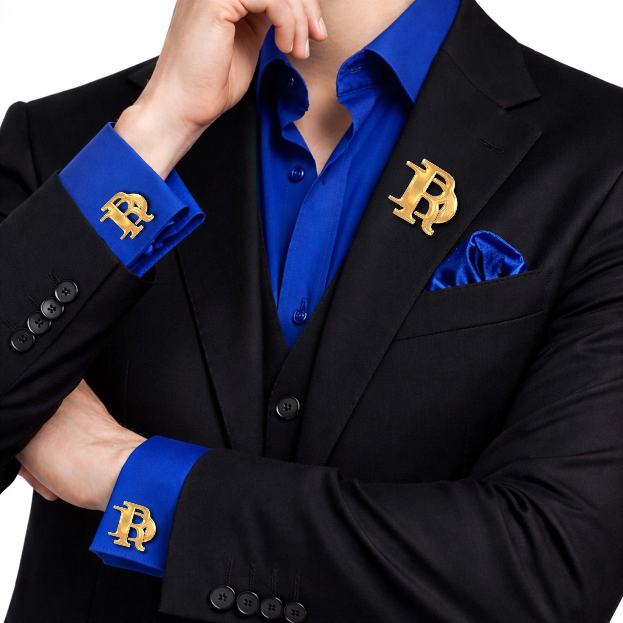Gold interlocking initials cufflinks and matching lapel pin set worn with a black suit and royal blue shirt