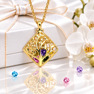 Gold rhombus family tree necklace with birthstones on gift box