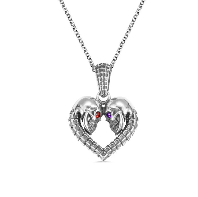 Silver chain necklace with heart-shaped skull pendant and colored gem eyes on a white background.