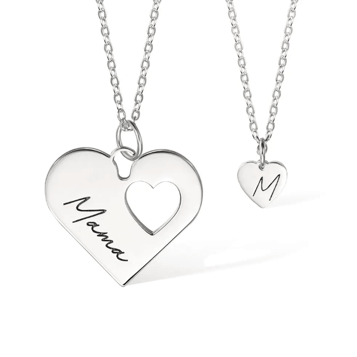 Silver layered heart necklace set with customizable engravings 'Mama' and 'M', symbolizing the special bond between mother and child on a white background.