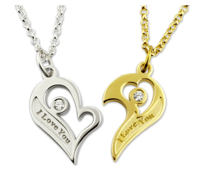 A pair of complementary heart-shaped pendants, one in silver and one in gold, each with a gemstone and "I Love You" inscription, attached to matching chains.