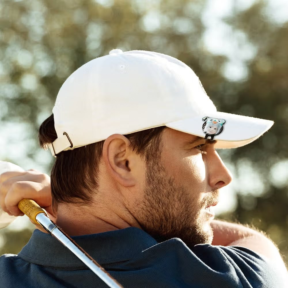 Golfer wearing custom pet photo golf ball marker with magnetic hat clip on white cap