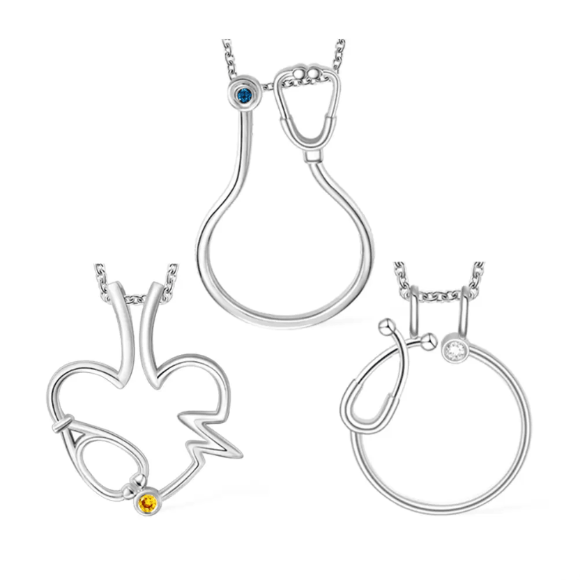 Silver ring holder necklaces with stethoscope, heart, and EKG designs. Each pendant features a customizable birthstone, perfect for medical professionals.