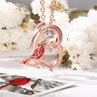 Rose gold 'Dear grandma is near' engraved cardinal necklace with purple gemstone.