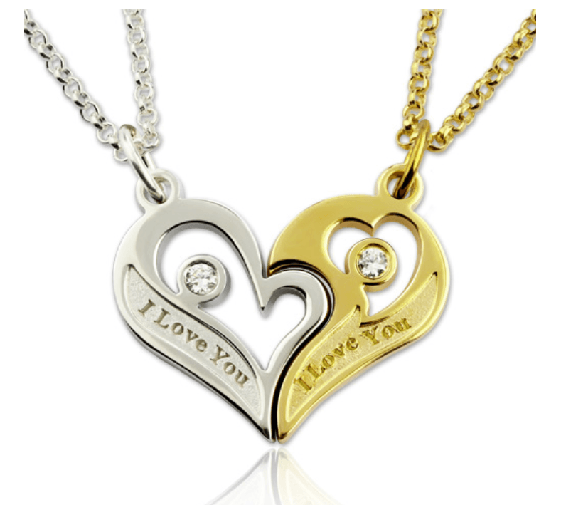 A pair of heart-shaped pendants, one silver and one gold, each with a small gemstone and inscribed with "I Love You," connected to matching chains.