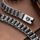 Detailed view of a Tibetan Om Mani Padme Hum spinner bracelet with intricate patterns and secure clasp on a leather background.