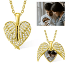 Gold heart locket with angel wings and rhinestones, featuring a family photo inside.