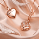 Rose gold heart locket with 'Love you forever' inscription and winged design on silky background.