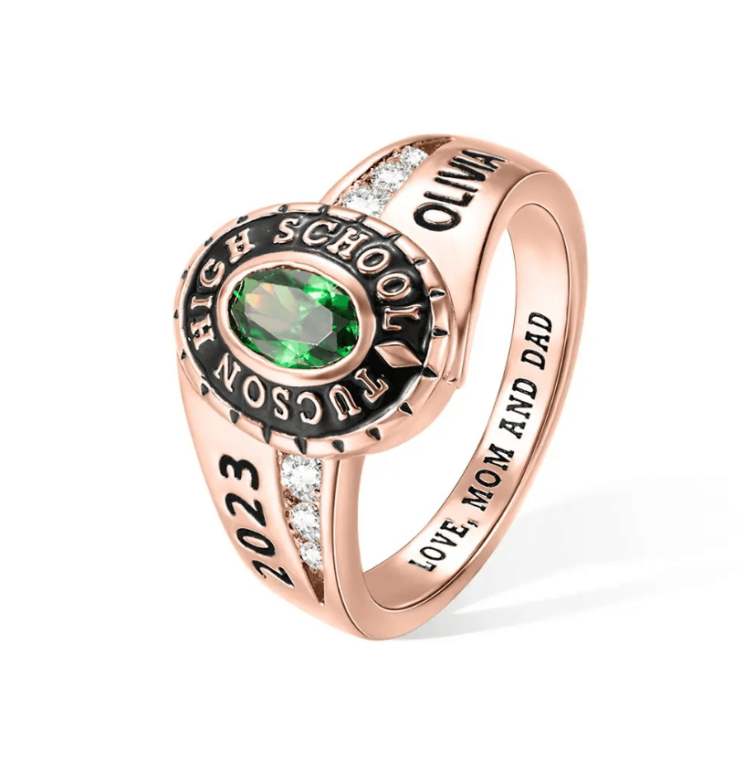 2023 rose gold high school class ring with green stone and 'Love Mom and Dad' engraving.