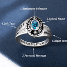 Custom silver class ring with blue birthstone, engraved with school name and congratulatory message.