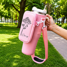 Pink tumbler carrier with phone pocket, custom birth flower design and shoulder strap