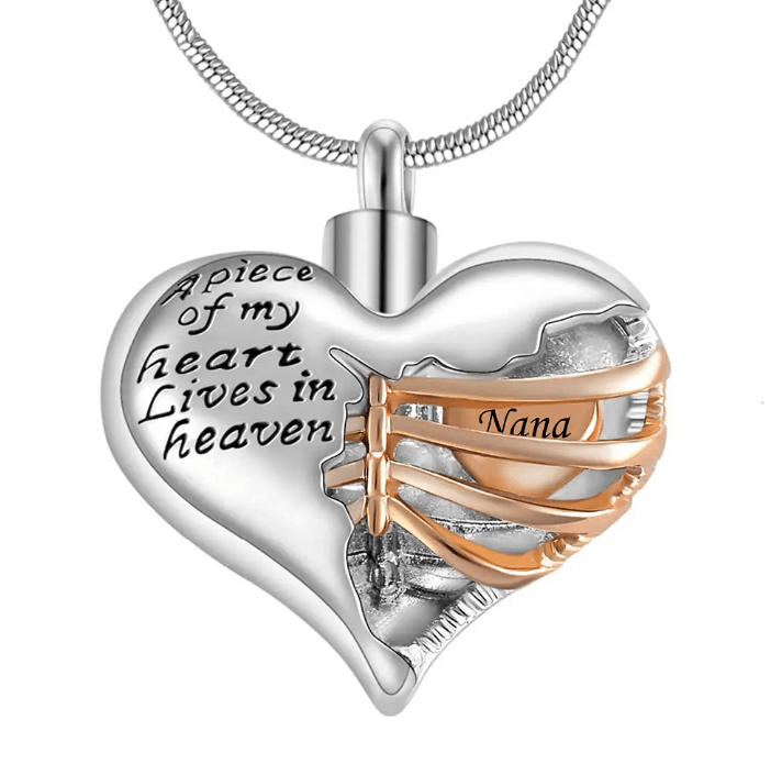 A heart-shaped pendant with the inscription "A piece of my heart lives in heaven," featuring a gold ribbon with the word "Nana."