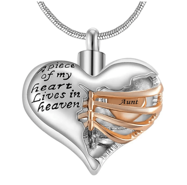 A heart-shaped pendant with the inscription "A piece of my heart lives in heaven," featuring a gold ribbon with the word "Aunt."