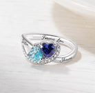 Silver ring with two heart gems in blue shades and "Justin & Shawna Forever Love" engraving.