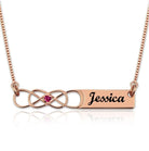 Personalized Double Infinity Knot Necklace with Birthstone in Rose Gold, featuring the name "Jessica" engraved on a rectangular pendant.