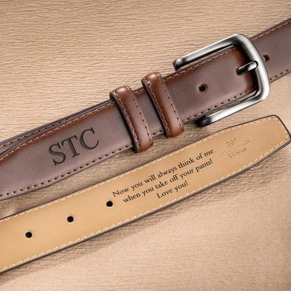 Brown leather belt with a silver buckle and embossed initials 'STC', featuring a romantic engraved message on the inside.