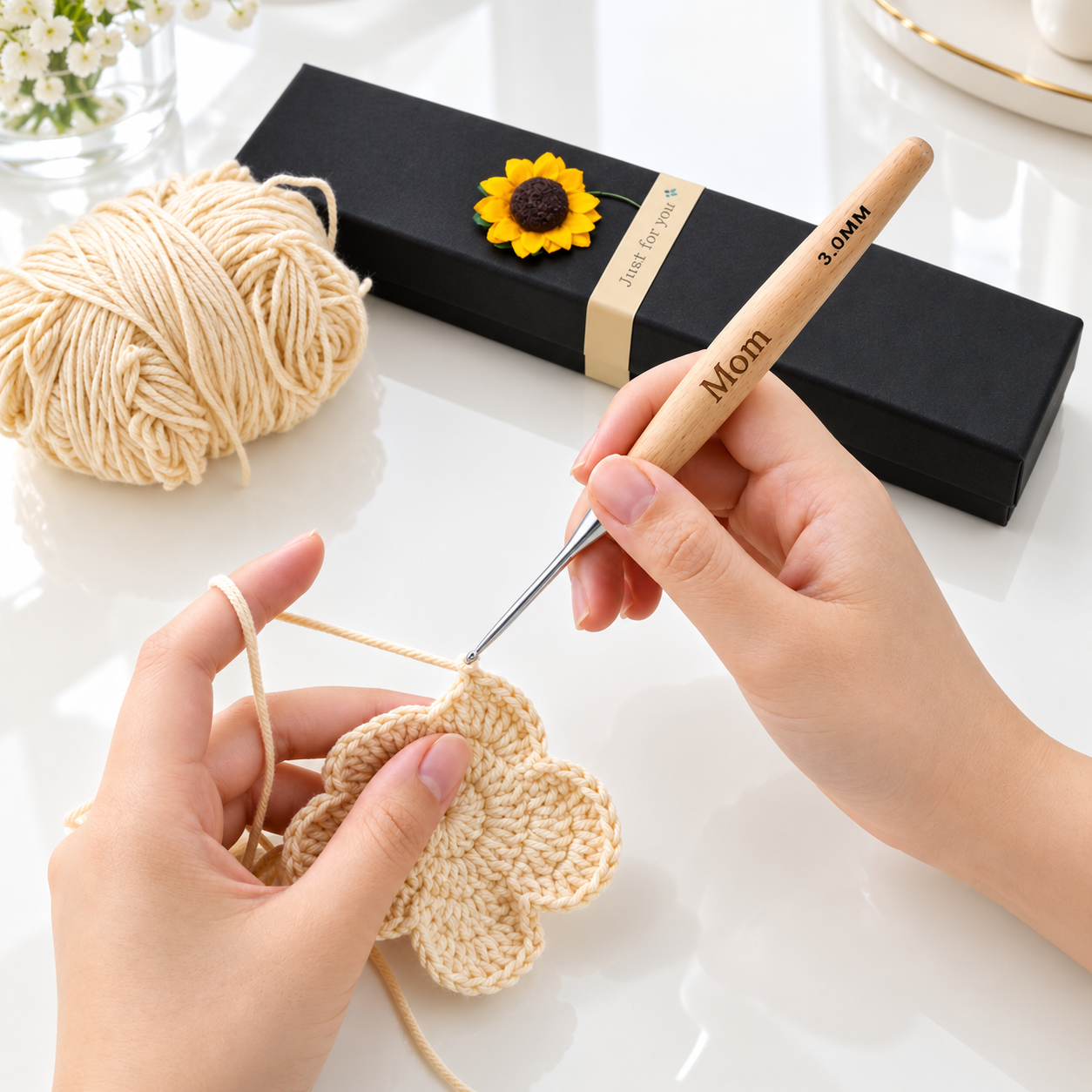 Personalized crochet hook set being used with engraved wooden handle and sunflower gift box