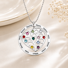 Silver heart family tree necklace with names and birthstones on a light background
