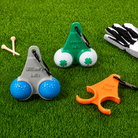 Personalized grey green and orange golf ball holders displayed on grass