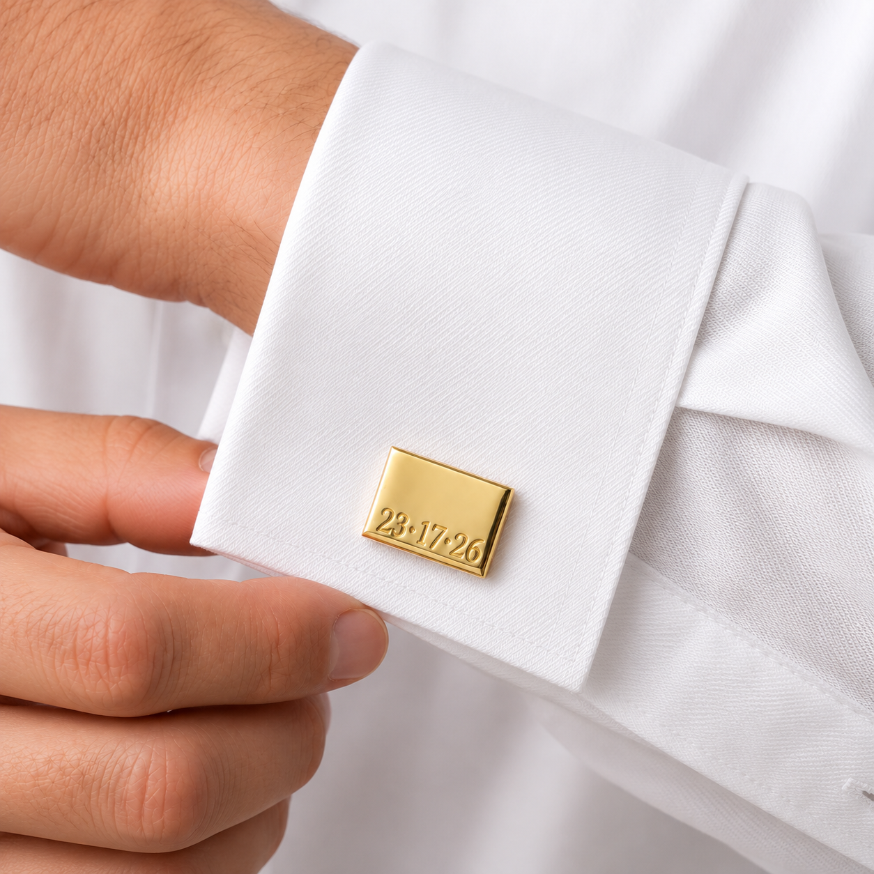 Custom gold cufflink with engraved date on white wedding shirt
