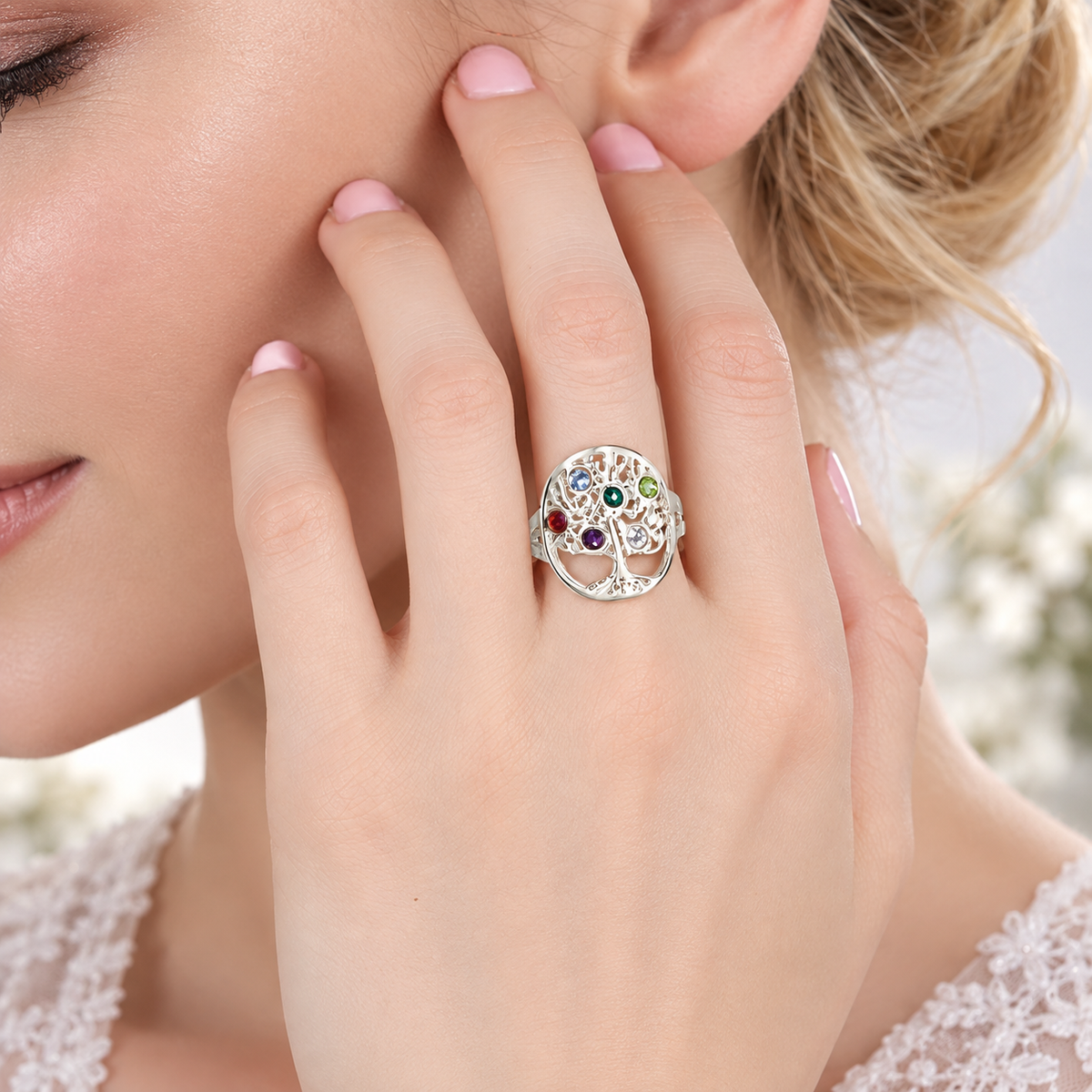 Woman wearing a silver personalized family tree birthstone ring
