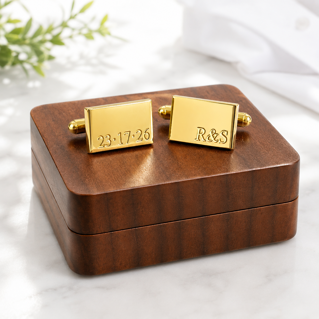 Personalized gold cufflinks displayed on custom wooden gift box